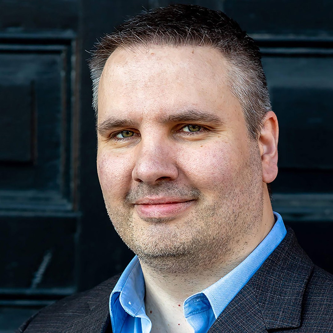 Headshot of Cameron Macdonell smiling
